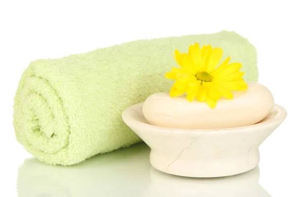 Rolled green towel, soap bar and beautiful flower isolated on white — Stock Photo, Image