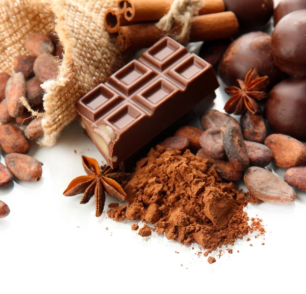 Composition of chocolate sweets, cocoa and spices, isolated on white — Stock Photo, Image