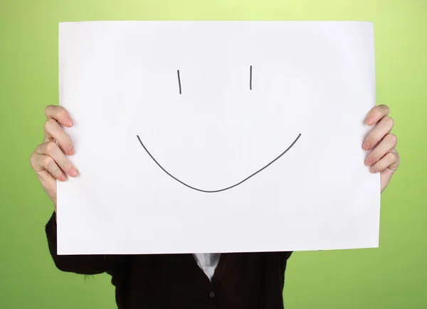 Woman holding paper with smile, on color background — Stock Photo, Image