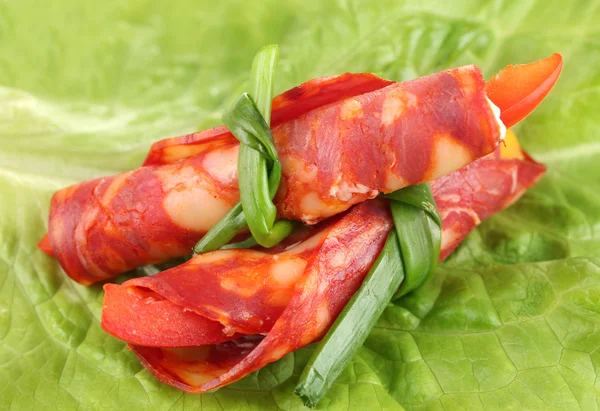 Salami rolls on wooden board, close up — Stock Photo, Image