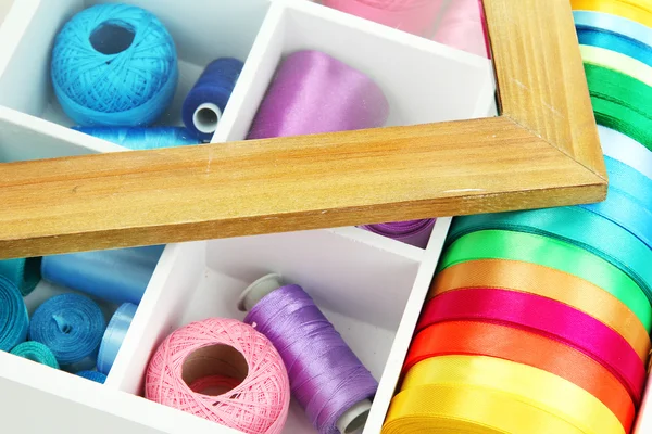 Material for sewing in white wooden box closeup — Stock Photo, Image