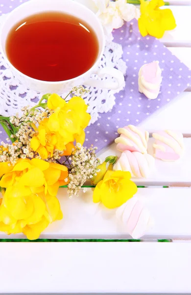 Piękną kompozycję z kubkiem herbaty i ptasie mleczko na piknik drewniany stół szczegół — Zdjęcie stockowe