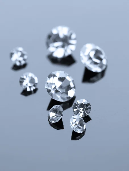 Beautiful shining crystals (diamonds), on grey background — Stock Photo, Image