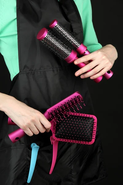 Hairdresser in uniform with working tools, isolated on black — Stockfoto