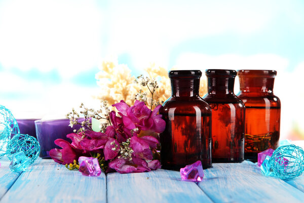 Spa oil and freesia on light background