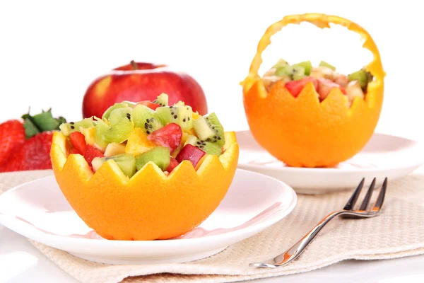 Fruit salad in hollowed-out orange isolated on white — Stock Photo, Image