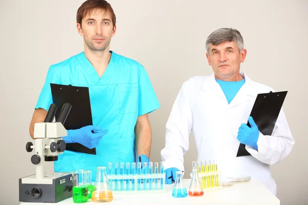 Physician and assayer during research on room background — Stock Photo, Image