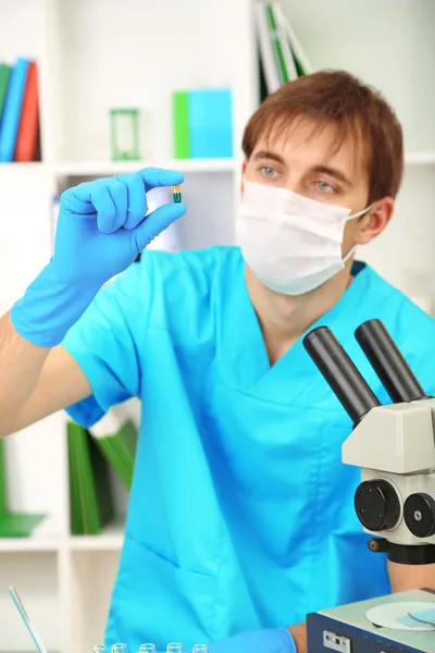 Assayer during research on room background — Stock Photo, Image