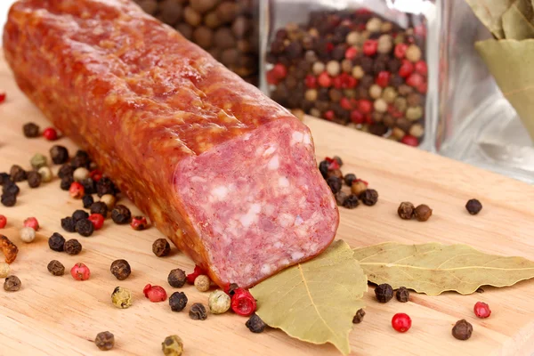 Tasty sausage on chopping board close-up — Stock Photo, Image