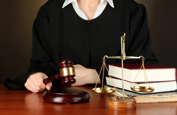 Judge sitting at table during court hearings on black background — Stock Photo, Image