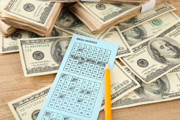 Lottery ticket,money and pencil on wooden background — Stock Photo, Image