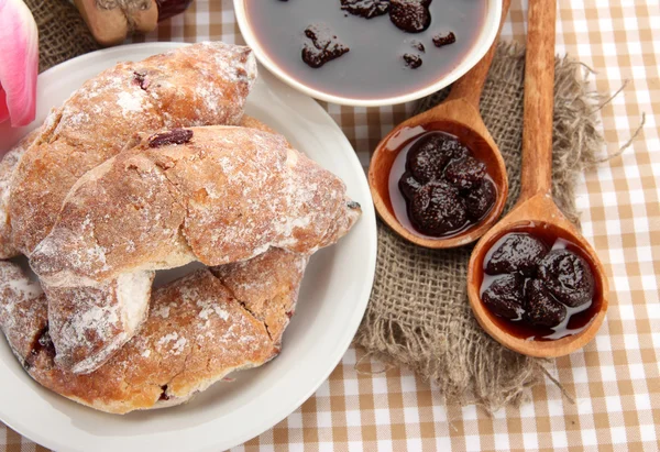 Taste croissants on plate and jam on tableclot — Stock Photo, Image