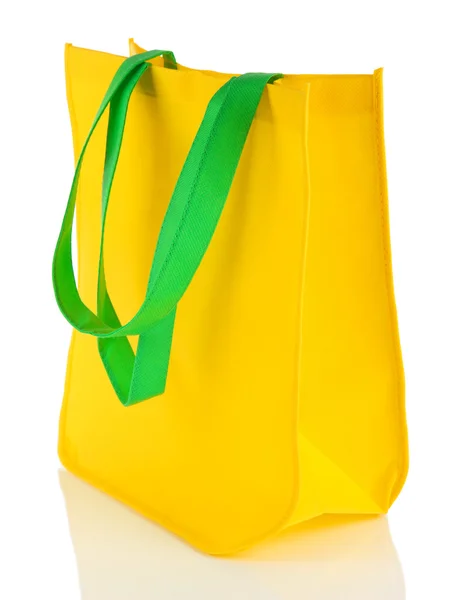 Желтый мешок с зелеными ручками изолирован на белом — стоковое фото