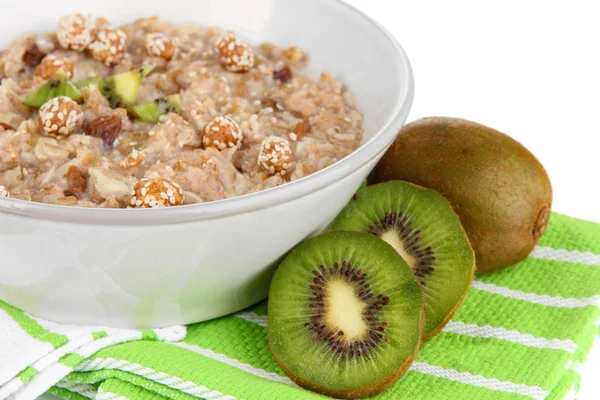 Useful oatmeal in bowl with fruit isolated on white — Stock Photo, Image