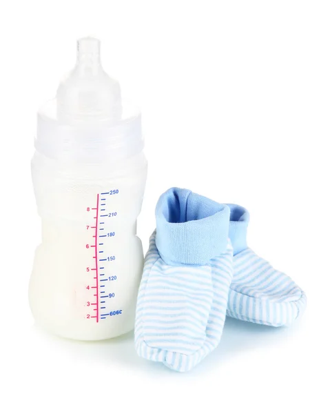 Bottle for milk formula with booties isolated on white — Stock Photo, Image