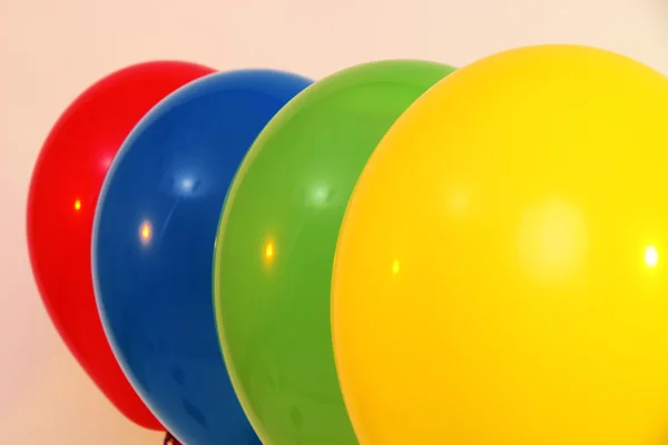 Quattro palloncini luminosi su sfondo chiaro — Foto Stock