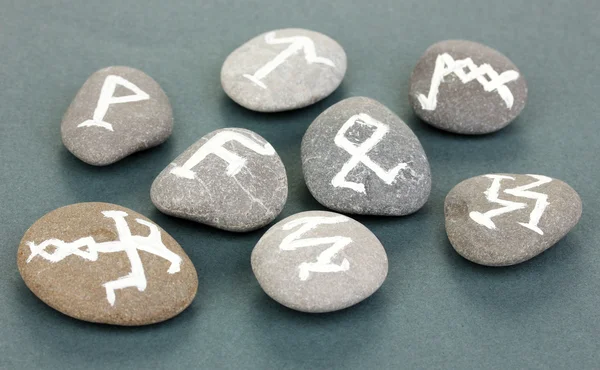 Fortune telling with symbols on stones on grey background — Stock Photo, Image