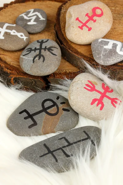 Fortune telling with symbols on stones on white fur background — Stock Photo, Image