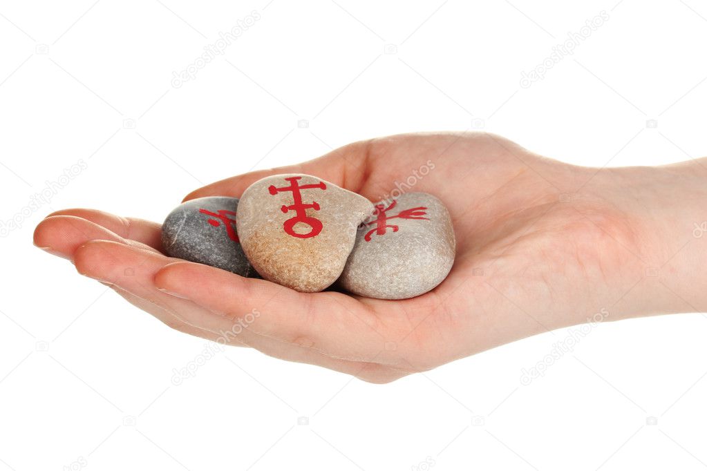 Fortune telling with symbols on stone in hand isolated on white