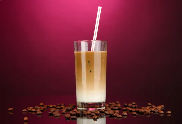 Cold coffee with ice in glass on color background — Stock Photo, Image