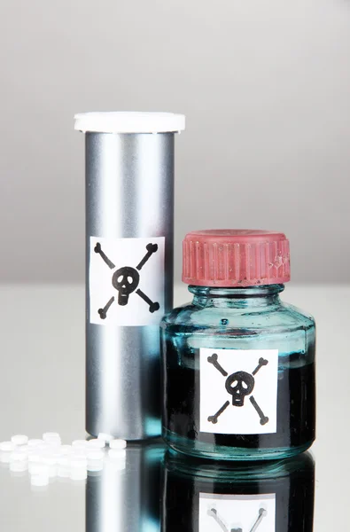 Deadly poison in bottles on grey background — Stock Photo, Image