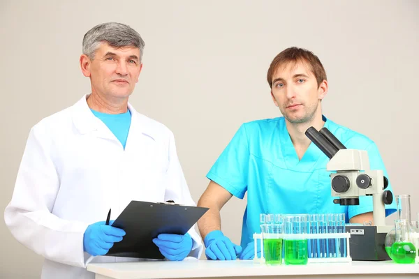 Physician and assayer during research on room background — Stock Photo, Image