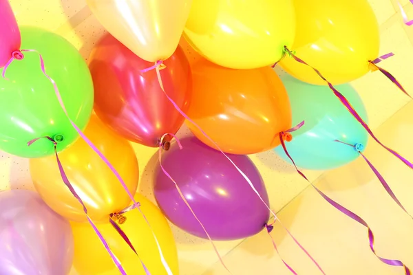 Many bright balloons under ceiling close-up — Zdjęcie stockowe