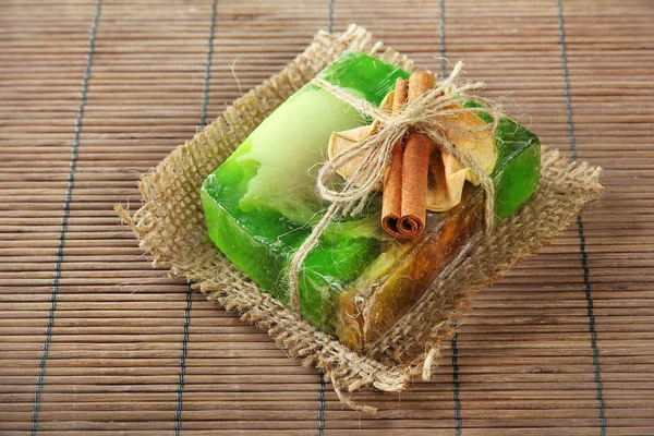 Hand-made soap on grey bamboo mat — Stock Photo, Image