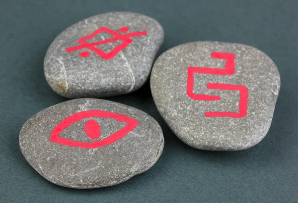 Fortune telling with symbols on stones on grey background — Stock Photo, Image