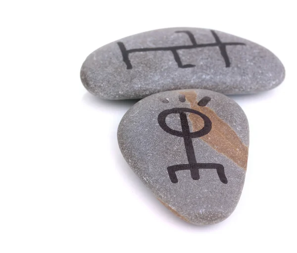 Contagem de fortuna com símbolos em pedras isoladas no branco — Fotografia de Stock