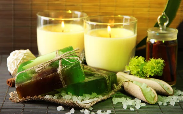 Hand made soap and candles on bamboo mat background — Stock Photo, Image