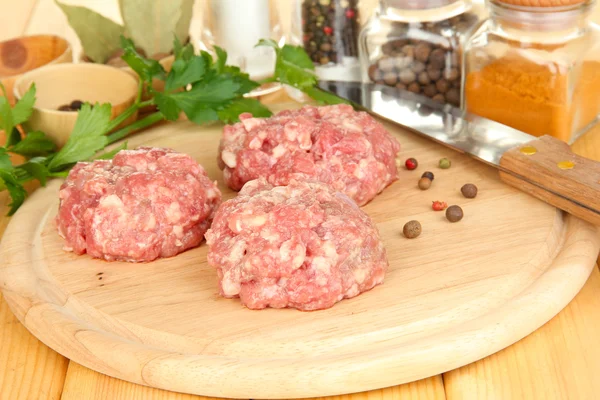 Raw meatballs with spices on wooden table — Stock Photo, Image