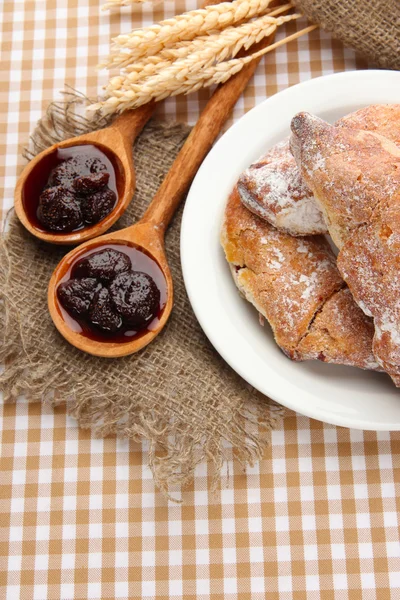 Taste croissants in basket and jam on tableclot — Stock Photo, Image