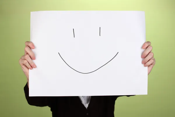 Woman holding paper with smile, on color background — Stock Photo, Image