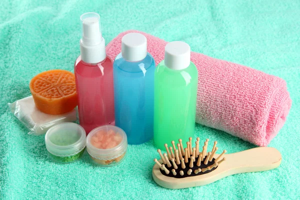 Hotel cosmetics kit on blue towel — Stock Photo, Image