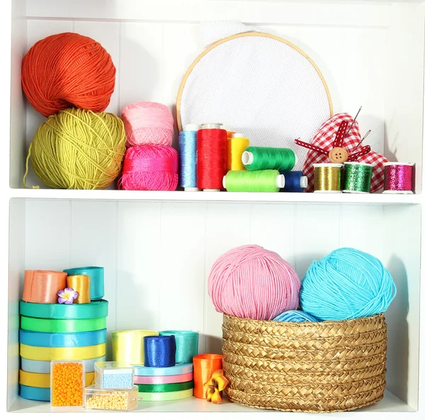 Beautiful white shelves with thread and material for handicrafts — Stock Photo, Image