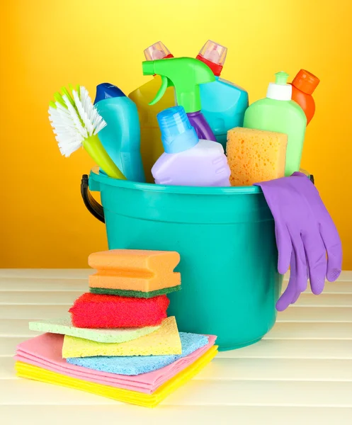 Cleaning items in bucket on color background — Stock Photo, Image