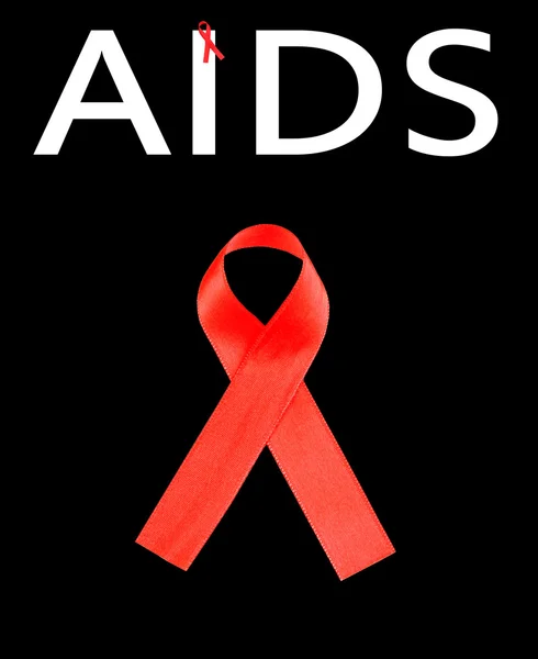 Aids consapevolezza nastro rosso isolato su nero — Foto Stock