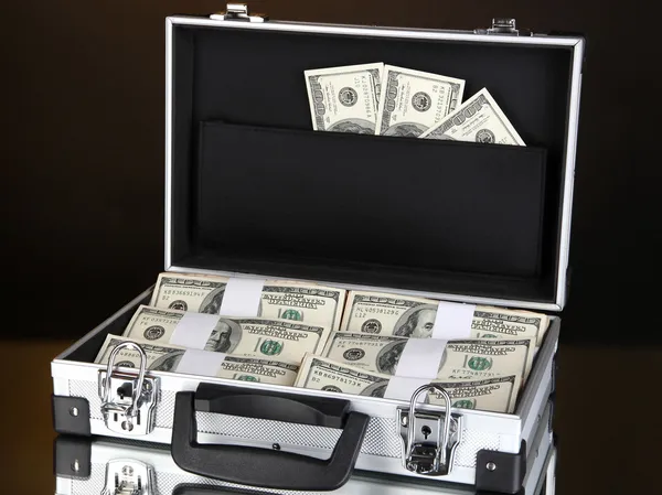 Suitcase with 100 dollar bills isolated on black — Stock Photo, Image