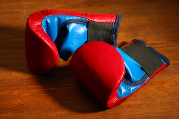 Small children boxing gloves on wooden background — Stock Photo, Image