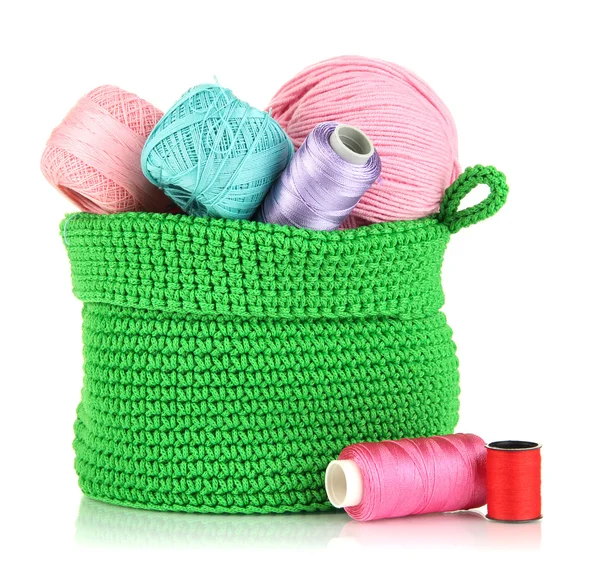 Colorful yarn for knitting in green basket isolated on white — Stock Photo, Image
