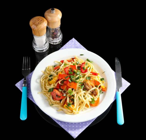 Noodles with vegetables on plate isolated on black — Stock Photo, Image