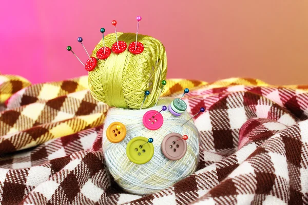 Buttons of different colors, and the two tangle thread on a colorful background