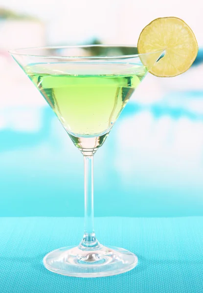 Green cocktail with lime on table on bright background — Stock Photo, Image