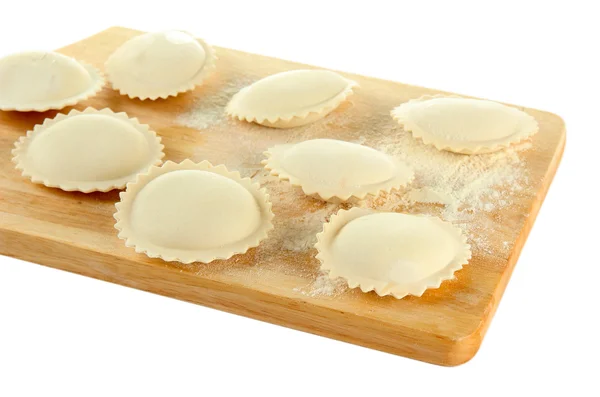 Raw dumplings on wooden desk, isolated on white — Stock Photo, Image