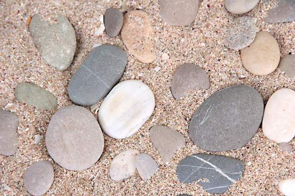 Zee stenen op zand achtergrond — Stockfoto