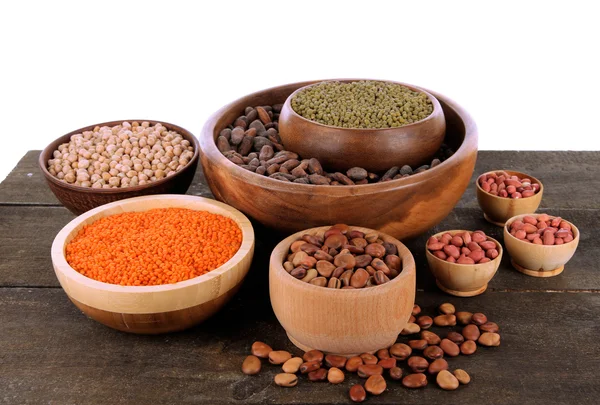 Different kinds of beans in bowls on table isolated on white — Stock Photo, Image