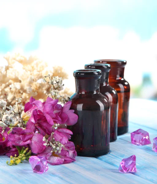 Spa oil and freesia on light background — Stock Photo, Image