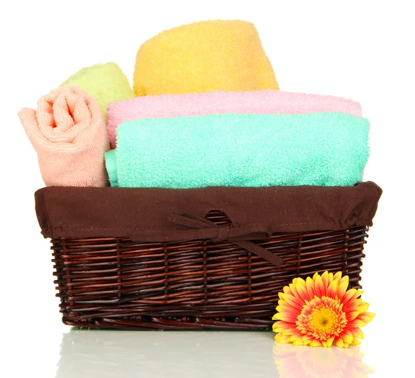 Bathroom towels folded in wicker basket isolated on white — Stock Photo, Image