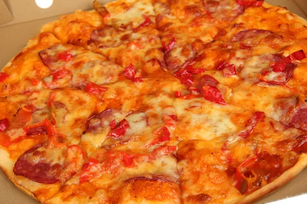 Tasty pizza in box close-up — Stock Photo, Image